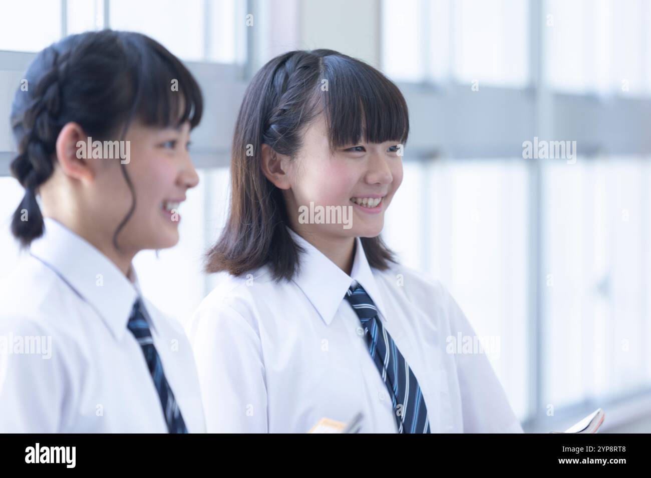 Junior high school students chatting in the corridor Stock Photo - Alamy