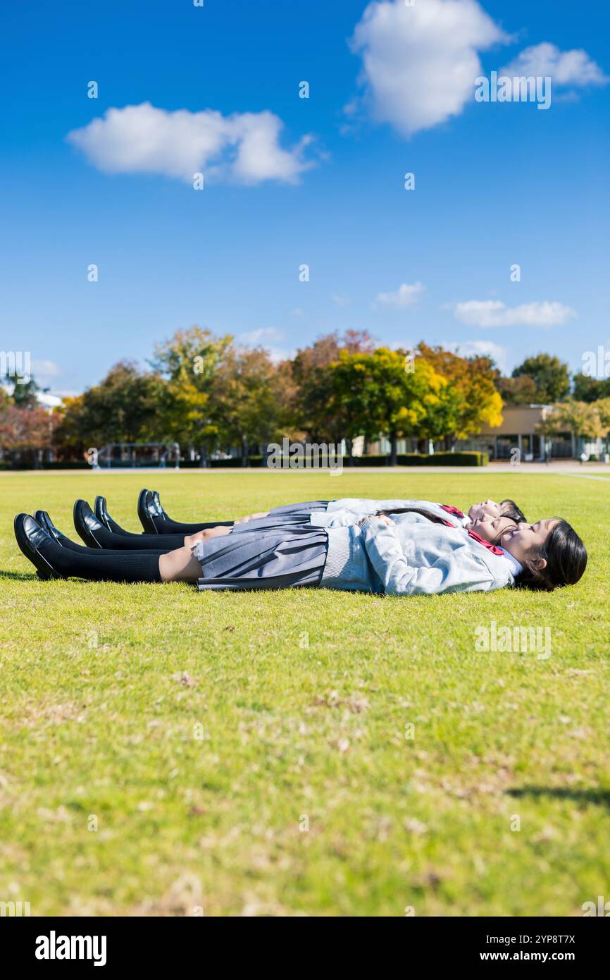 High school student lying on lawn Stock Photo - Alamy