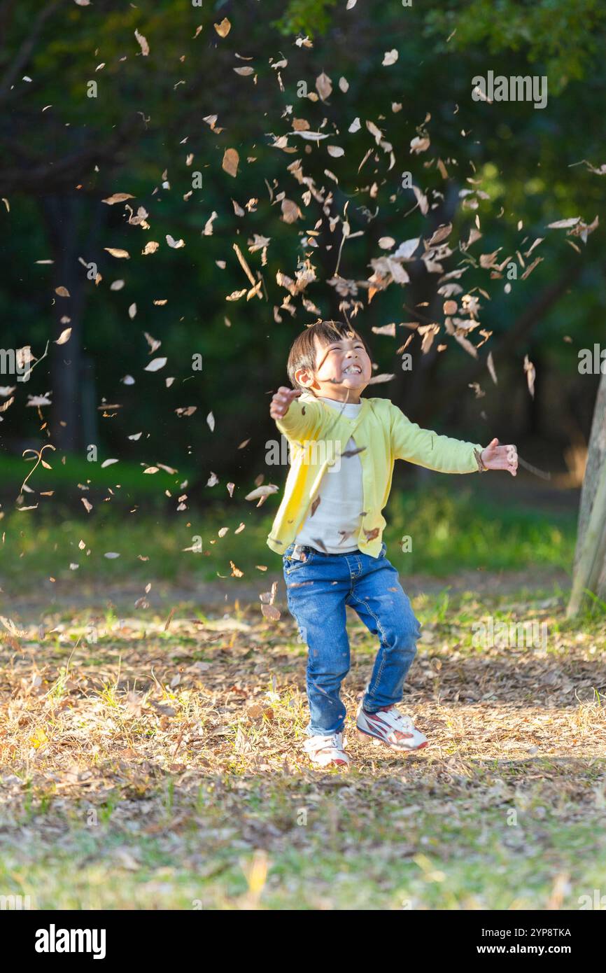 Child playing in dry grass hi-res stock photography and images - Alamy