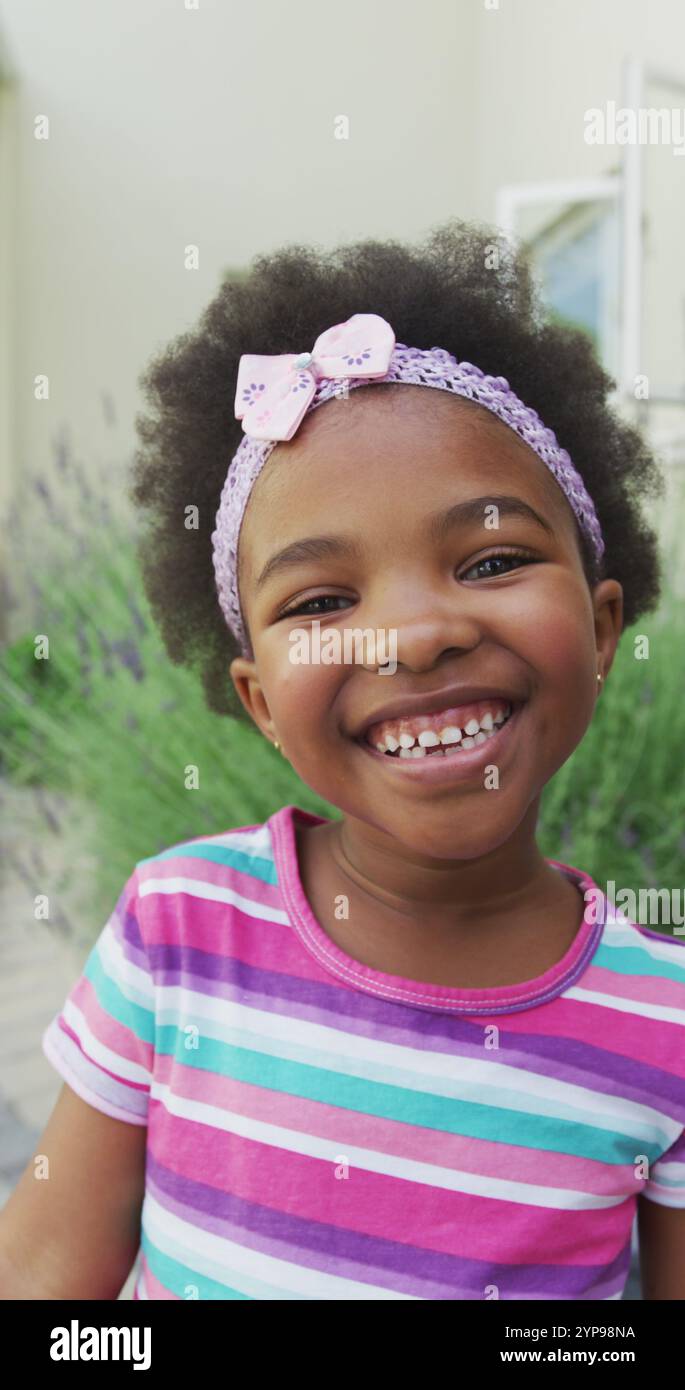 Vertical image portrait of happy african american girl smiling in ...