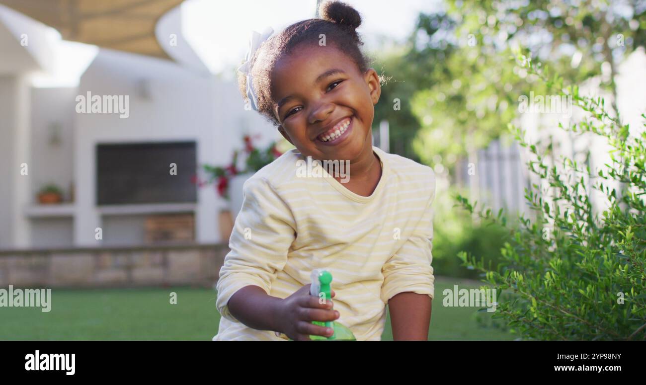 Happy african american girl watering hi-res stock photography and ...