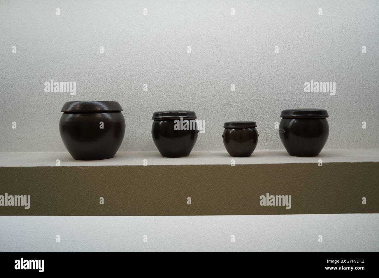 Miniature Korean jars on a shelf Stock Photo