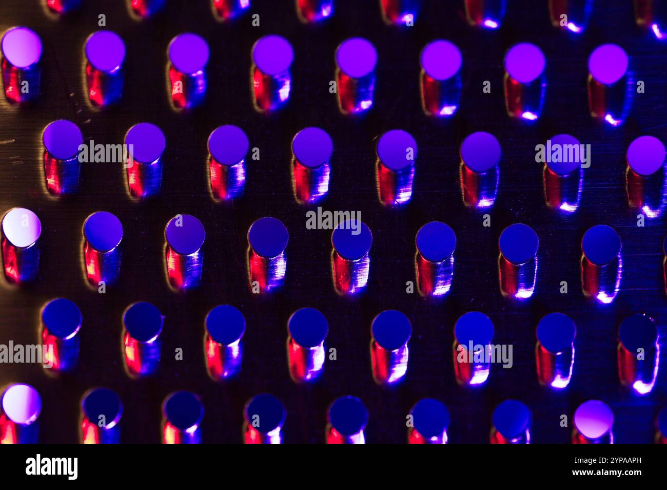 Blue and red light wash on stainless steel perforations Stock Photo