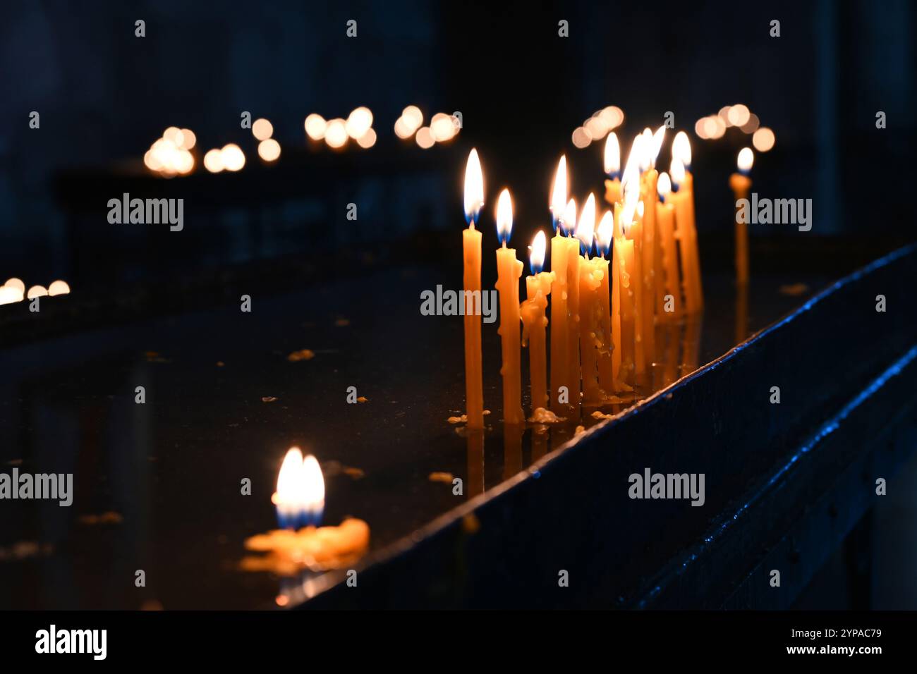 Burning church candles on black background Stock Photo - Alamy