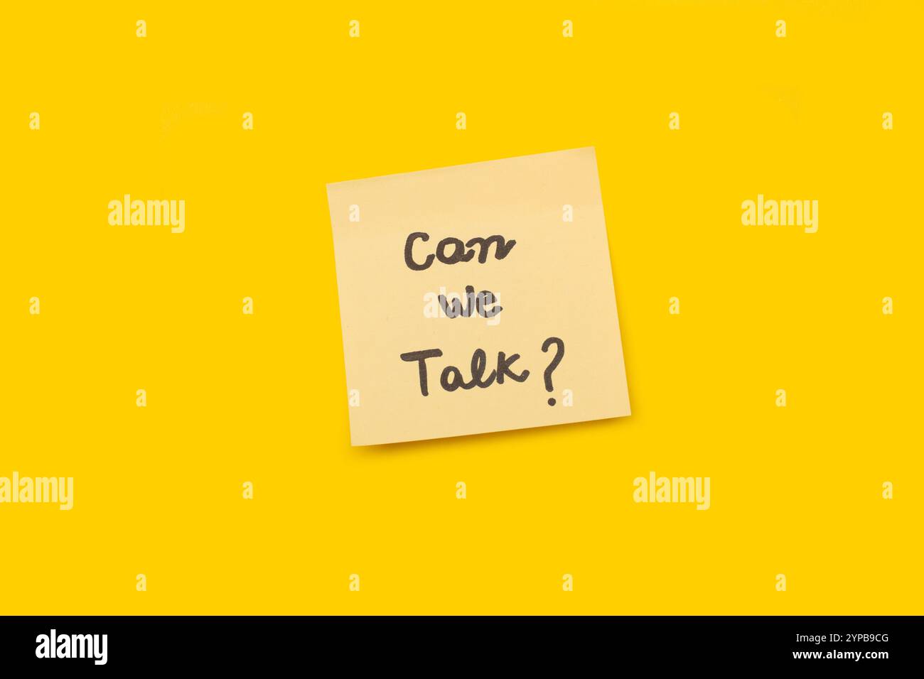 Can we talk handwritten on a yellow sticky paper on a yellow background with copy space Stock Photo
