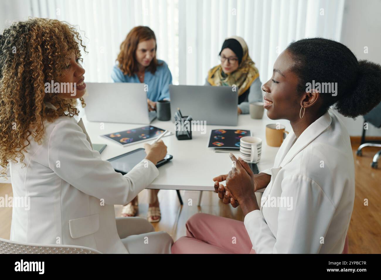 Collaborating in Modern Workspace with Diverse Team Stock Photo