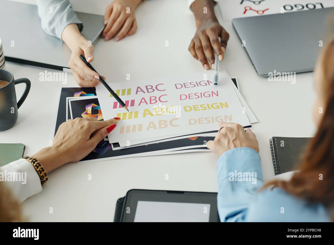 Collaborating on Colorful Design Project in Office Stock Photo