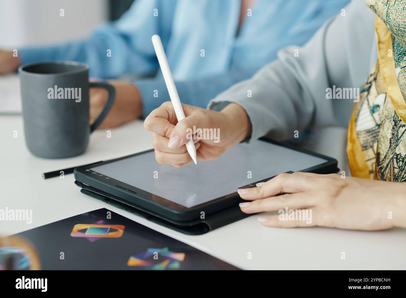 Using Stylus on Tablet for Digital Artwork in Office Stock Photo