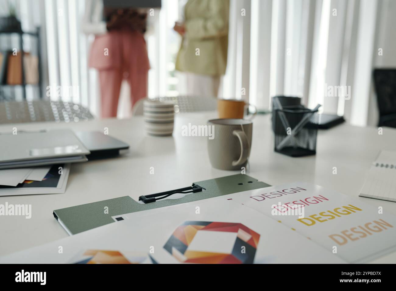 Collaborating in Modern Office Setting with Design Documents Stock Photo