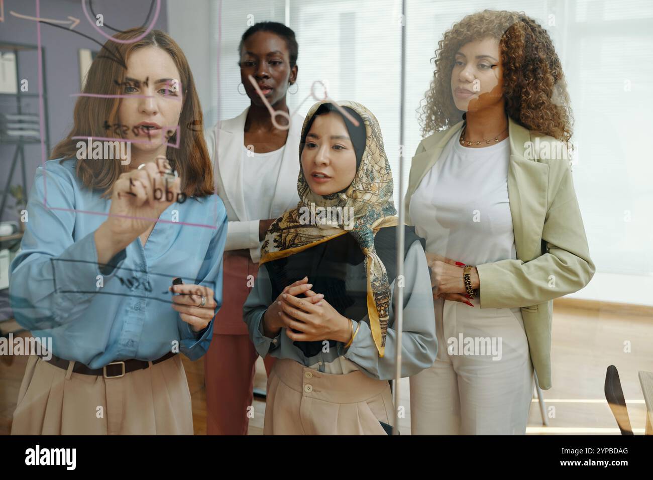 Collaborating on Project Plan in Modern Office Setting Stock Photo