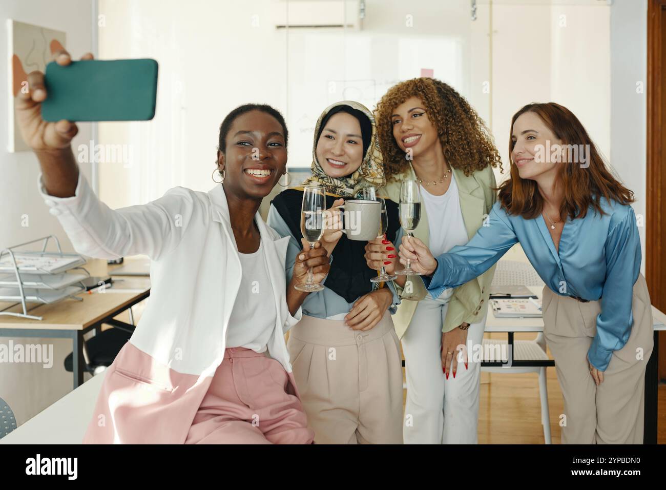 Smiling Colleagues Taking Group Selfie in Office Stock Photo