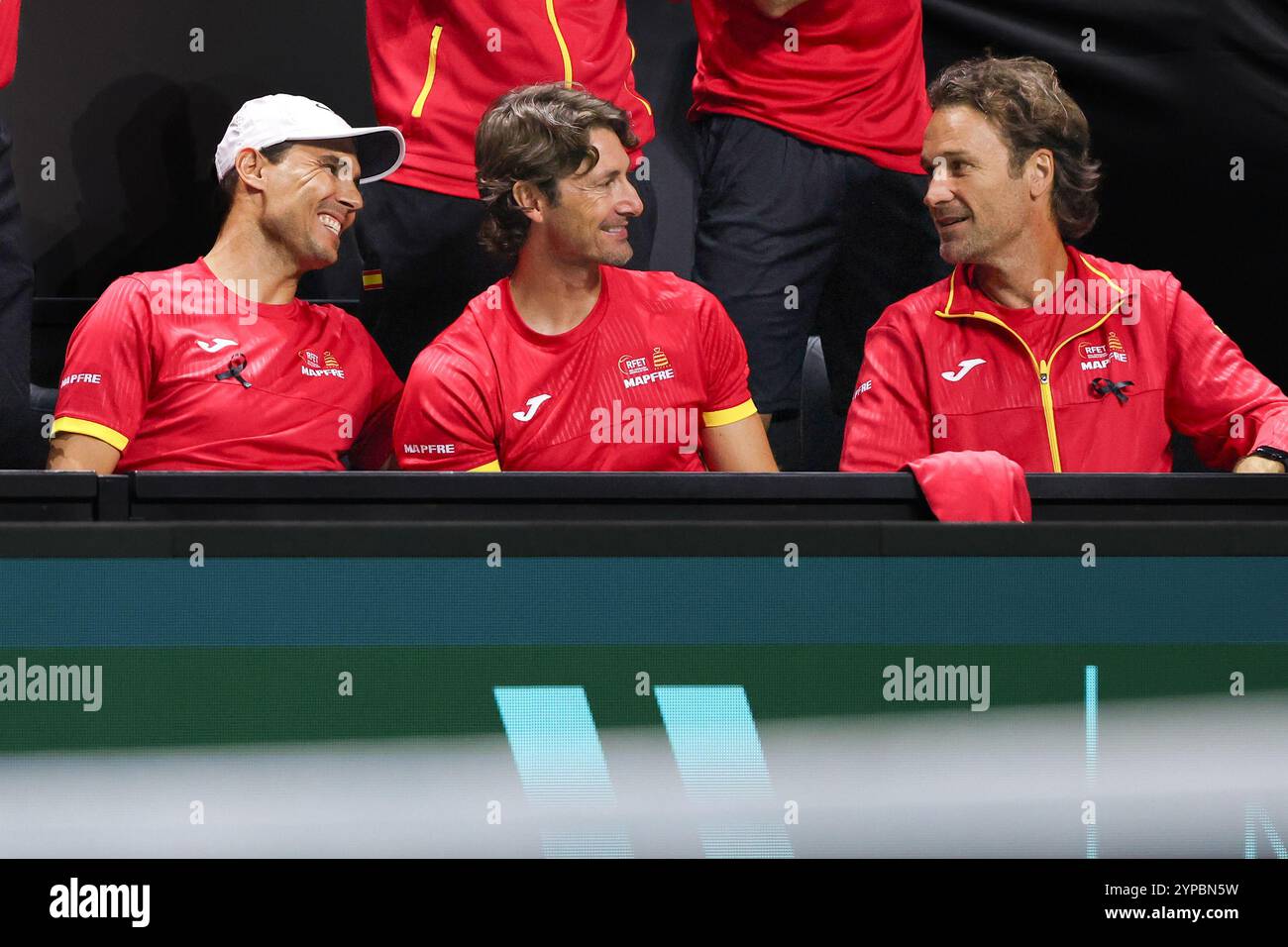 Team Spain with Rafael Nadal,coach Juan Carlos Ferrero and Carlos Moya  sitting in the players box at the 2024 Davis Cup finals at the Palacio de Depo Stock Photo