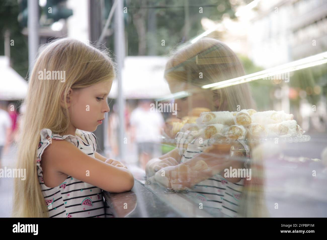 Grumpy and sad little girl looking at a cake store window Stock Photo ...