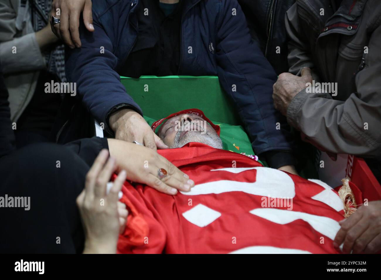 Tehran, Iran. 29th Nov, 2024. Iranians mourn while surrounding the coffin of Brigadier General Kiyomarth Porhashmi, a senior officer of the Islamic Revolutionary Guard Corps (IRGC) Quds Force, who was killed in Aleppo, Syria, during his funeral ceremony in Tehran. The IRGC Quds Force is a unit of Iran's Revolutionary Guard that conducts military, intelligence, and support operations abroad to advance Iran's regional influence. (Credit Image: © Rouzbeh Fouladi/ZUMA Press Wire) EDITORIAL USAGE ONLY! Not for Commercial USAGE! Stock Photo