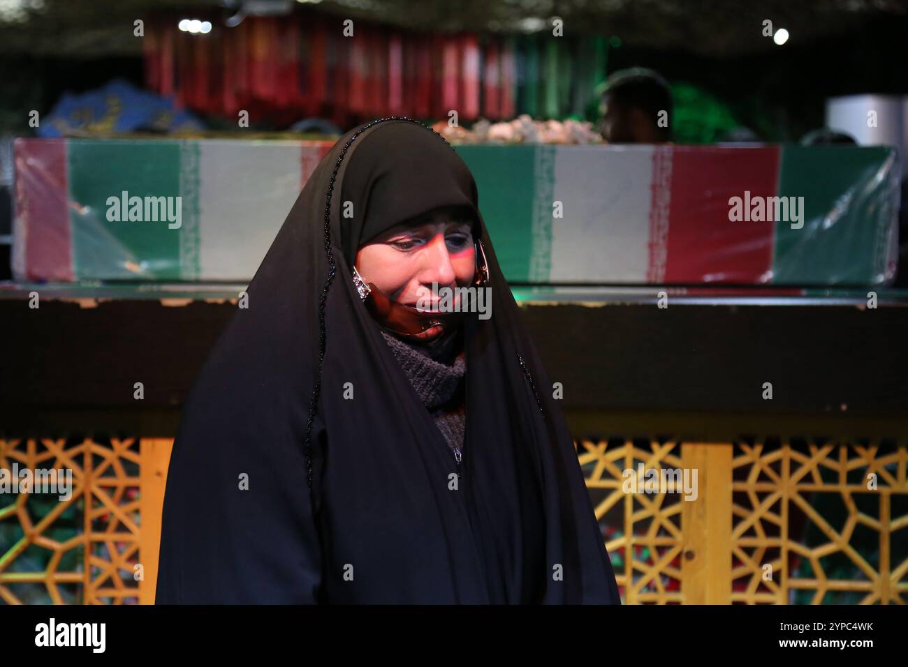 Tehran, Iran. 29th Nov, 2024. An Iranian veiled woman mourns during the funeral ceremony of Brigadier General Kiyomarth Porhashmi, a senior officer of the Islamic Revolutionary Guard Corps (IRGC) Quds Force, who was killed in Aleppo, Syria. The IRGC Quds Force is a unit of Iran's Revolutionary Guard that conducts military, intelligence, and support operations abroad to advance Iran's regional influence. (Credit Image: © Rouzbeh Fouladi/ZUMA Press Wire) EDITORIAL USAGE ONLY! Not for Commercial USAGE! Stock Photo