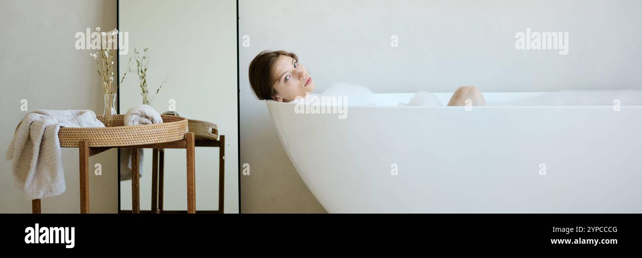Young woman lying in bathtub hi-res stock photography and images - Alamy