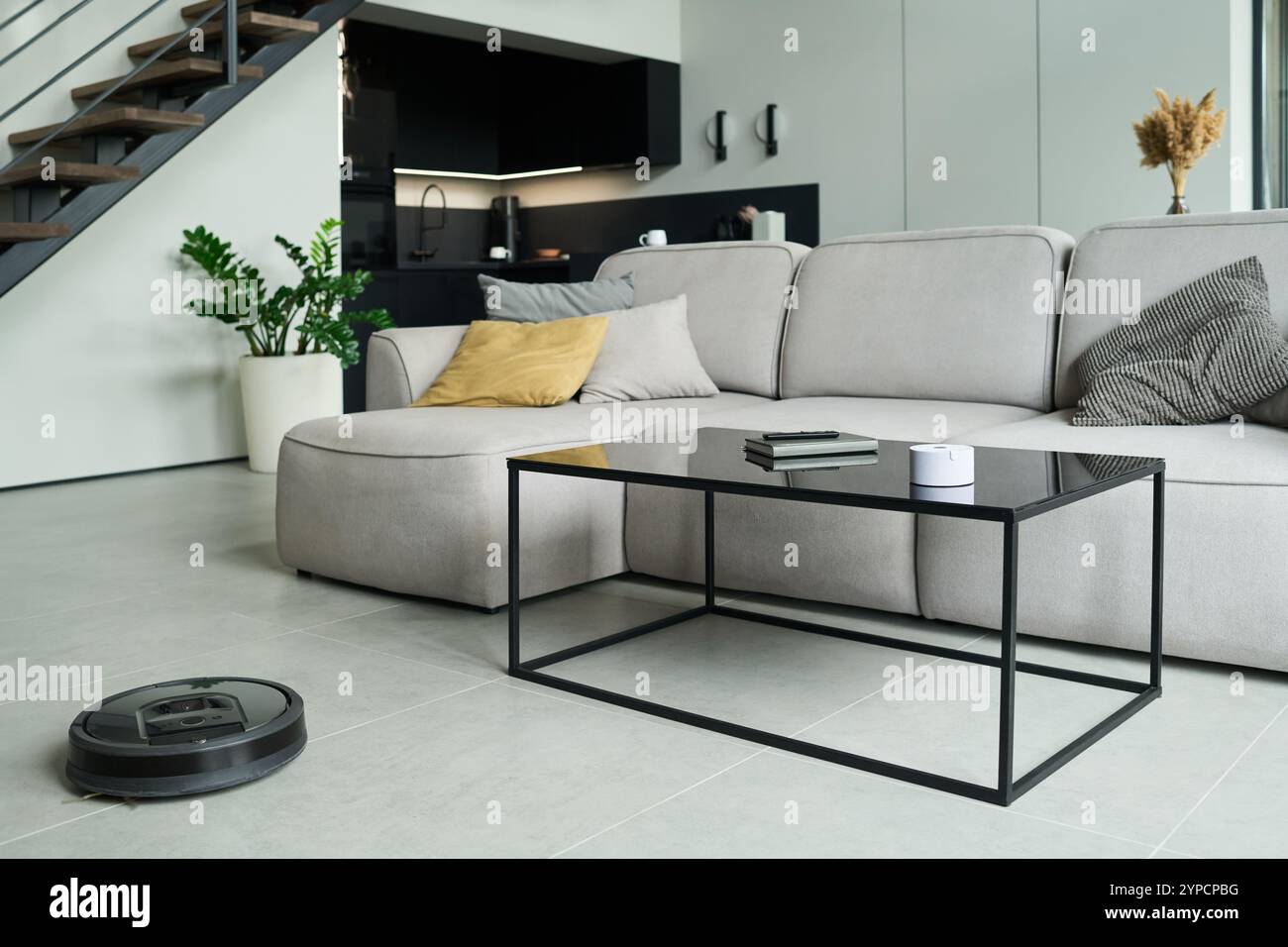 Modern minimalist living room featuring a sectional sofa, glass coffee ...