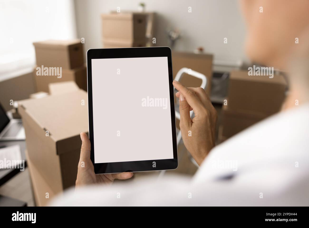 Internet shop manager using tablet computer in storage room Stock Photo