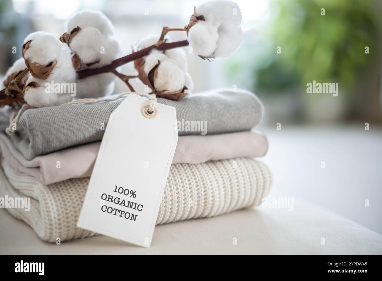 A neat stack of knitted clothing labeled 100 percent organic cotton ...