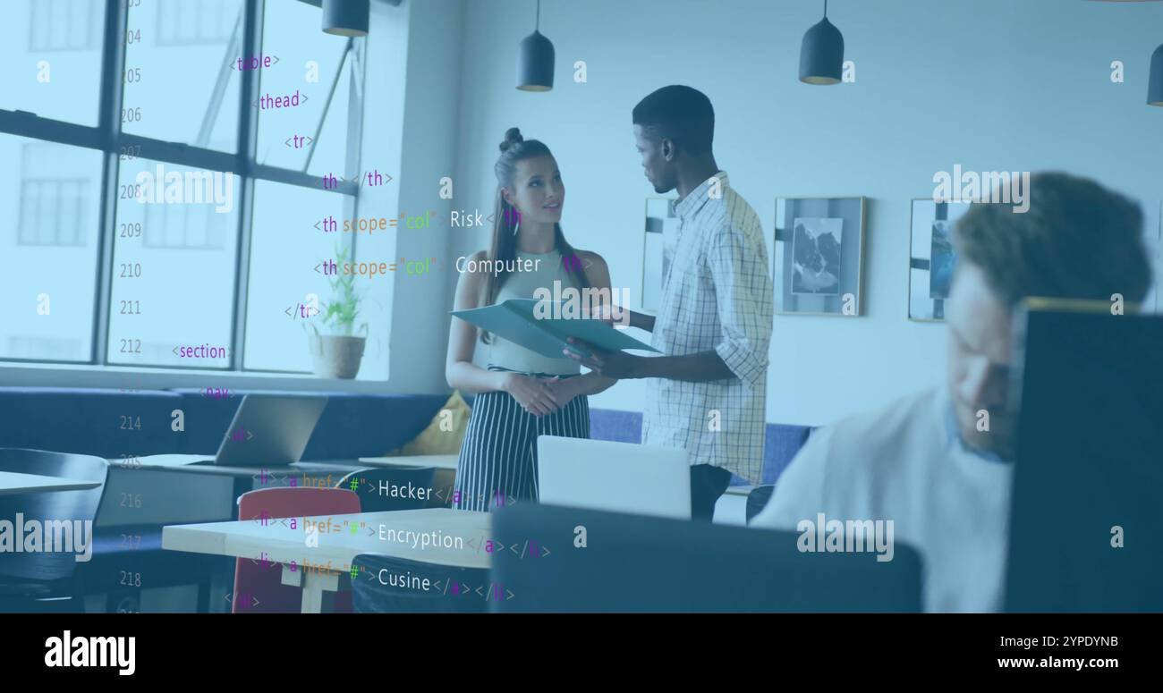 Computer code image over diverse colleagues discussing documents in modern office Stock Photo