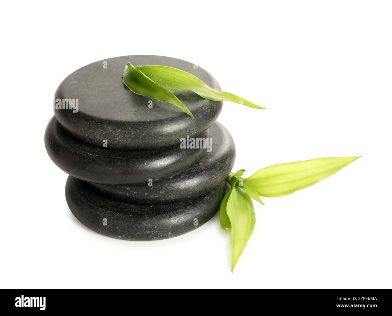 Spa stones and green leaves isolated on white Stock Photo - Alamy