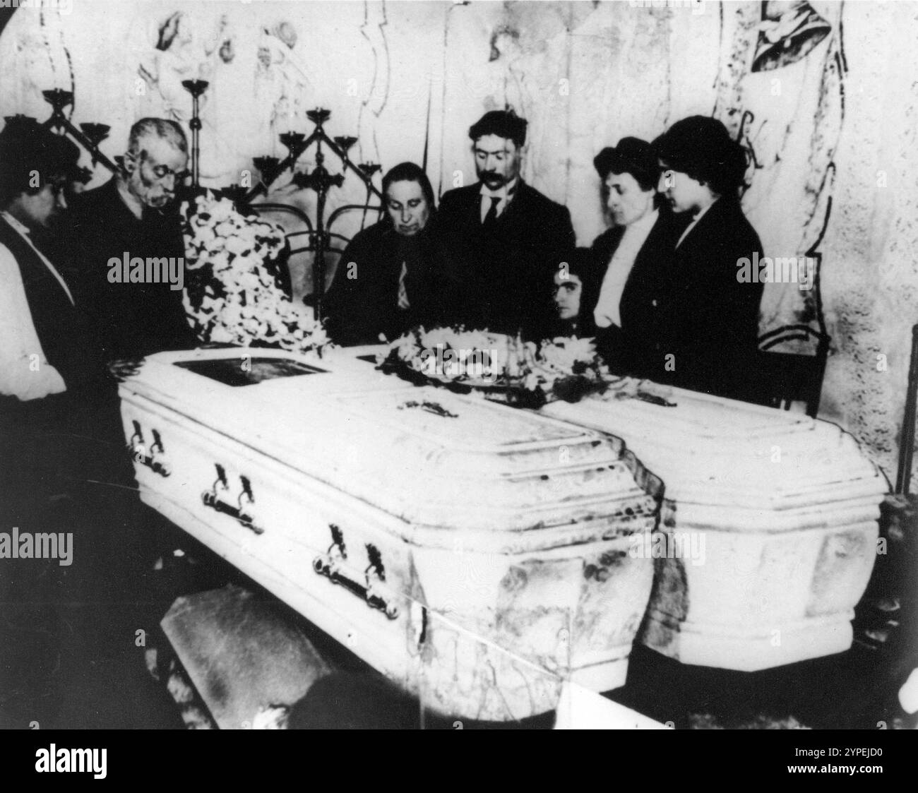 Mourners gather around two coffins holding Triangle fire victims. The