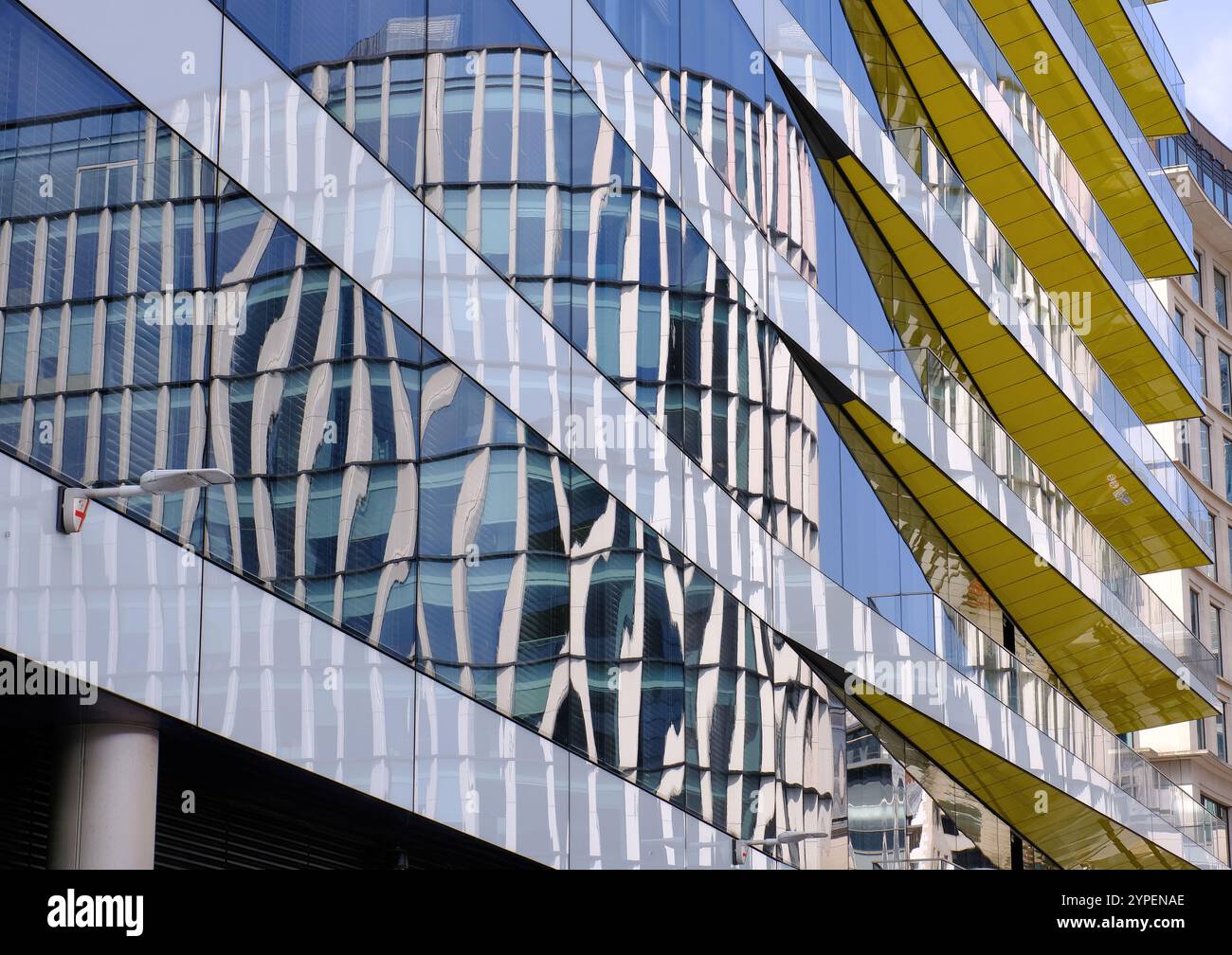Reflections of curved building at 40 King William Street in glass walls of building at 18 Swan Lane and Oystergate Walk in London, England, UK Stock Photo