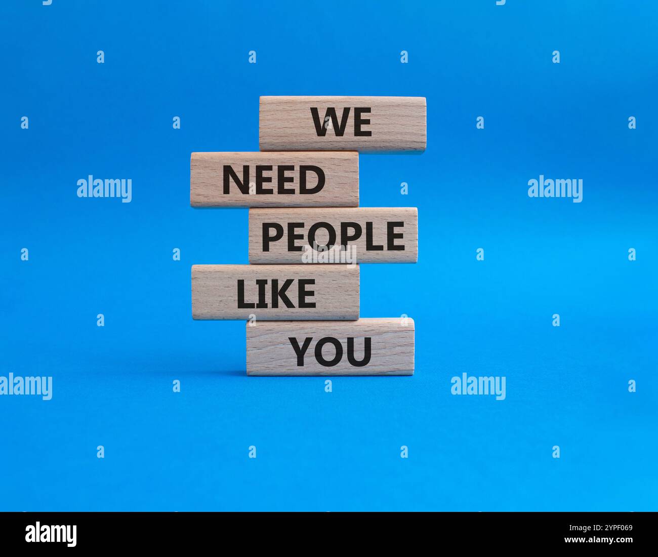 Hiring symbol. Wooden blocks with words We need People like You. Beautiful blue background. Business and Hiring concept. Copy space. Stock Photo