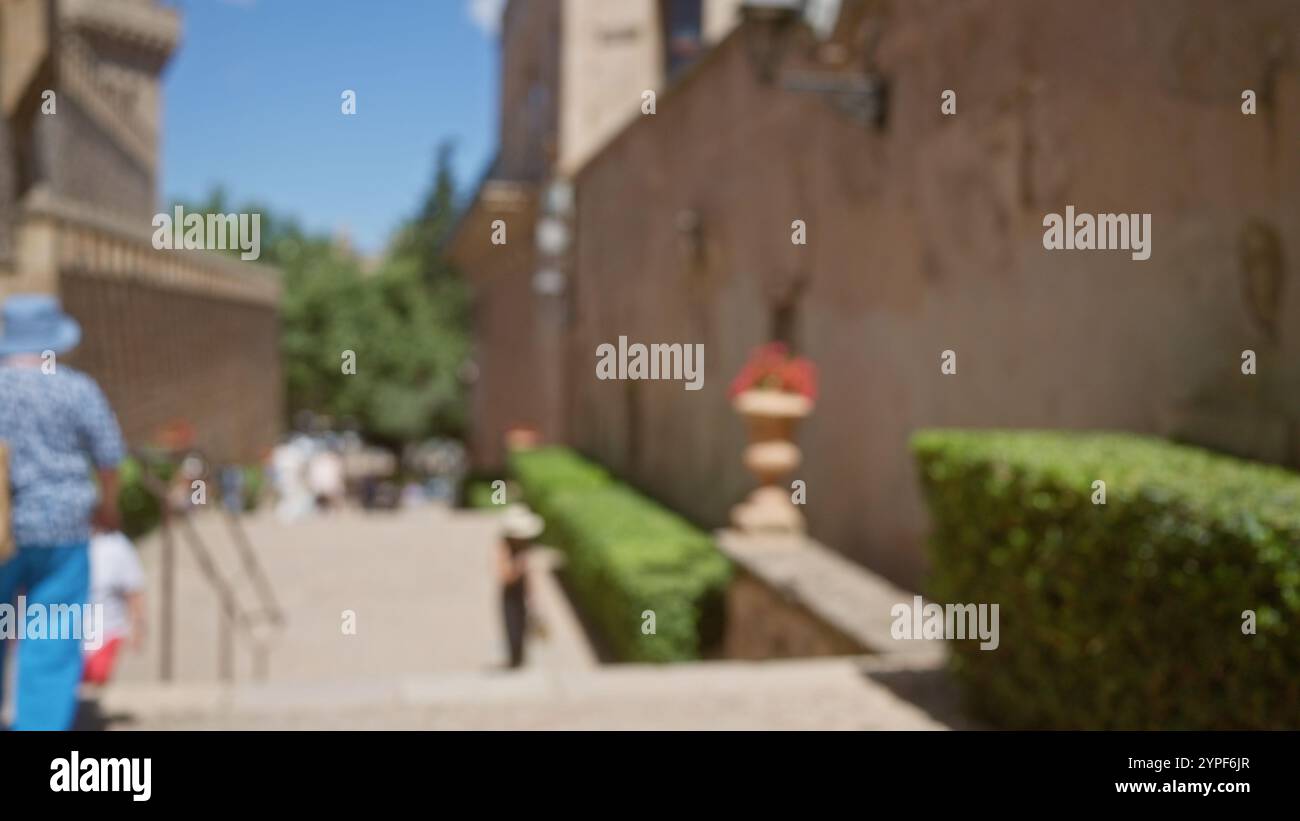 Blurred view of outdoor street in mallorca with people walking by ...