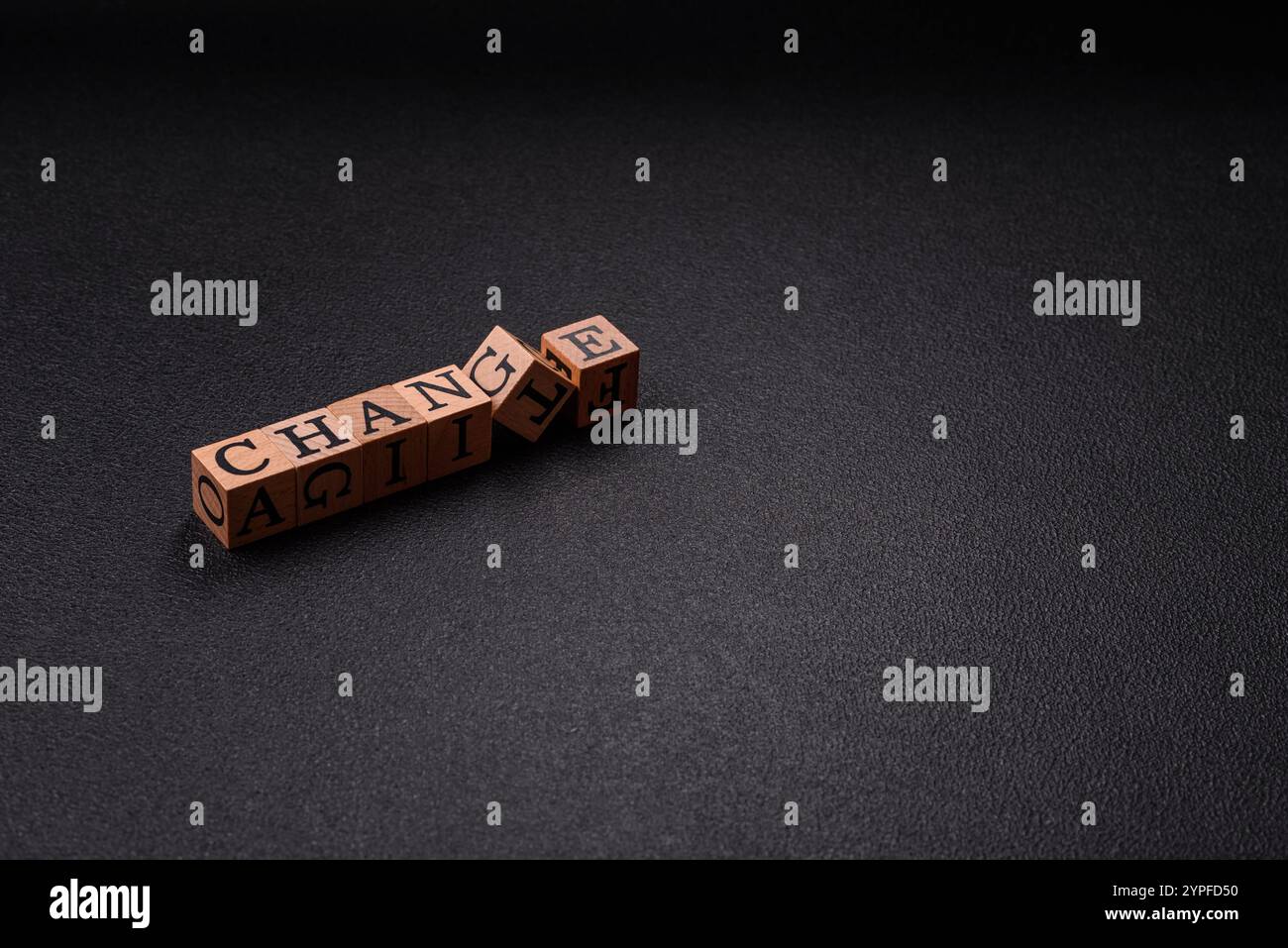 The inscription chance or change with wooden cubes on a dark concrete ...