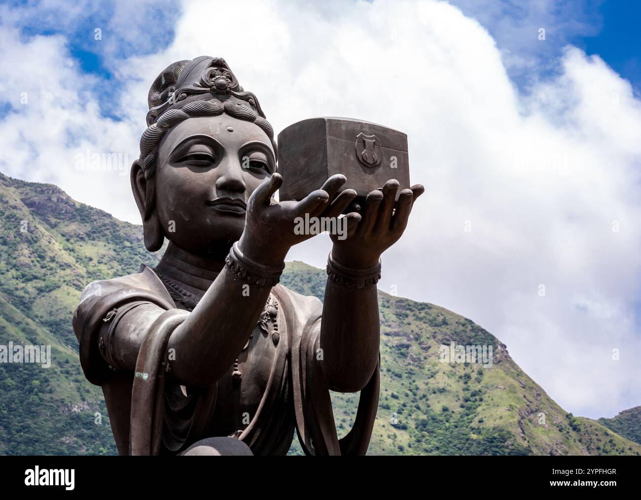 At the same site as the Big Buddah The Offering of the Six Devas that are posed offering flowers, incense, lamp, ointment, fruit, and music to the Bud Stock Photo