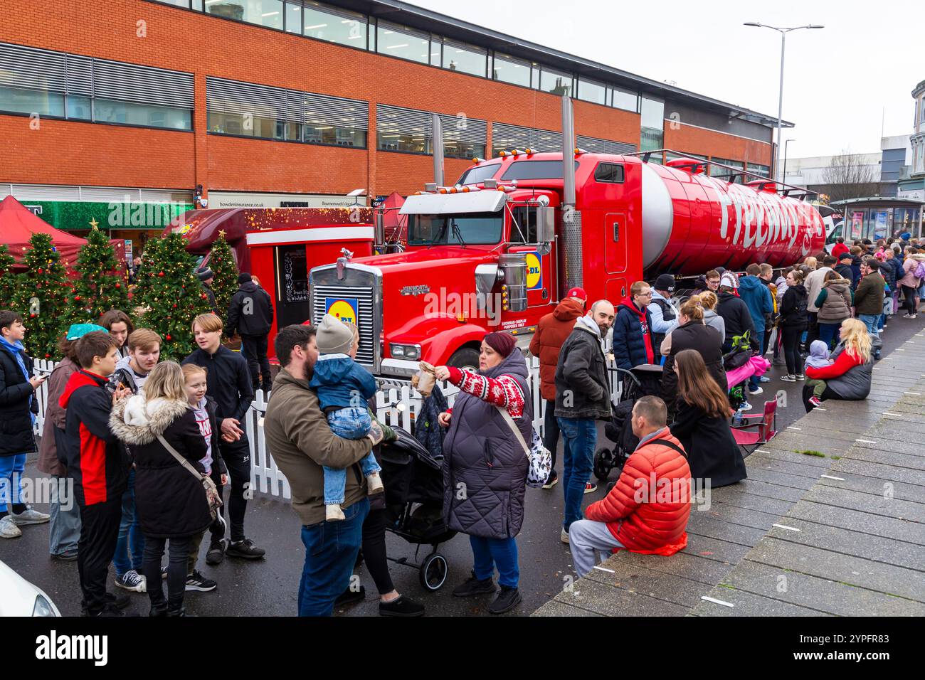 Bournemouth, Dorset, UK. 30th November 2024. Lidl's Christmas Freeway Truck arrives at the Triangle in Bournemouth, as part of its first ever Great British tour visiting 9 locations around the country. They are offering free gifts from the Middle of Lidl, food tasting and more, as they spread some festive magic leading up to Christmas. People get there early as long queues form with hundreds hoping to get freebies to help during the cost of living crisis. Credit: Carolyn Jenkins/Alamy Live News Stock Photo