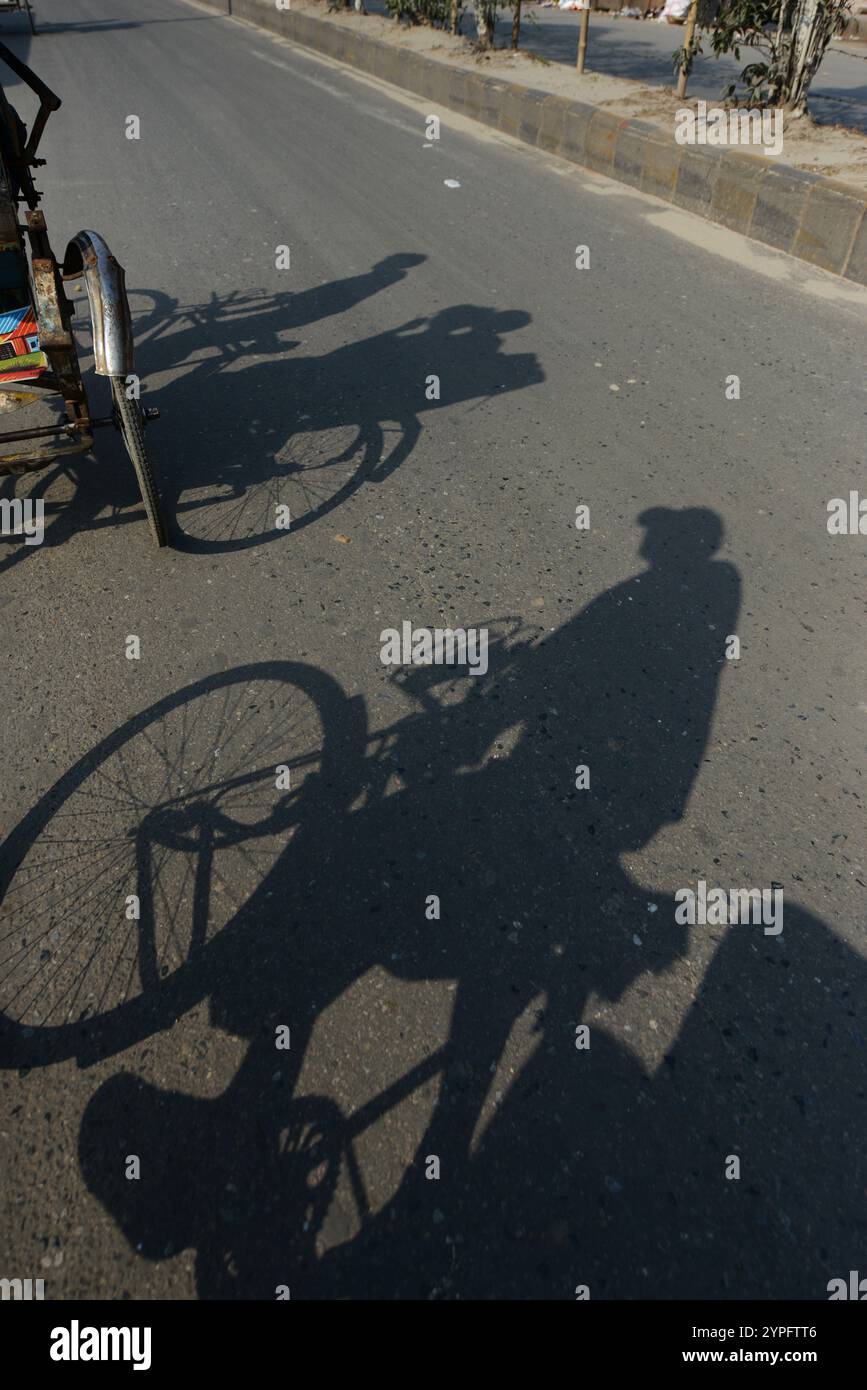 A shadow of a cycle rickshaw in Dhaka, Bangladesh Stock Photo - Alamy