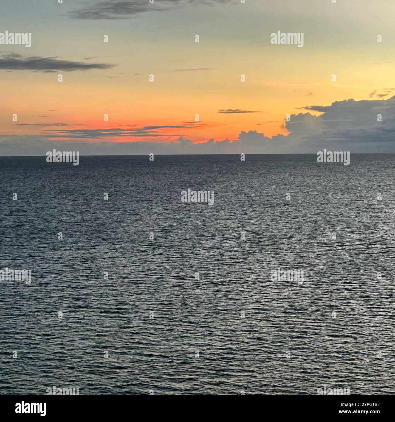 Sunset seen from a cruise ship in the Caribbean Sea, sailing in away from Belize, Central America - Smartphone Captured Stock Image