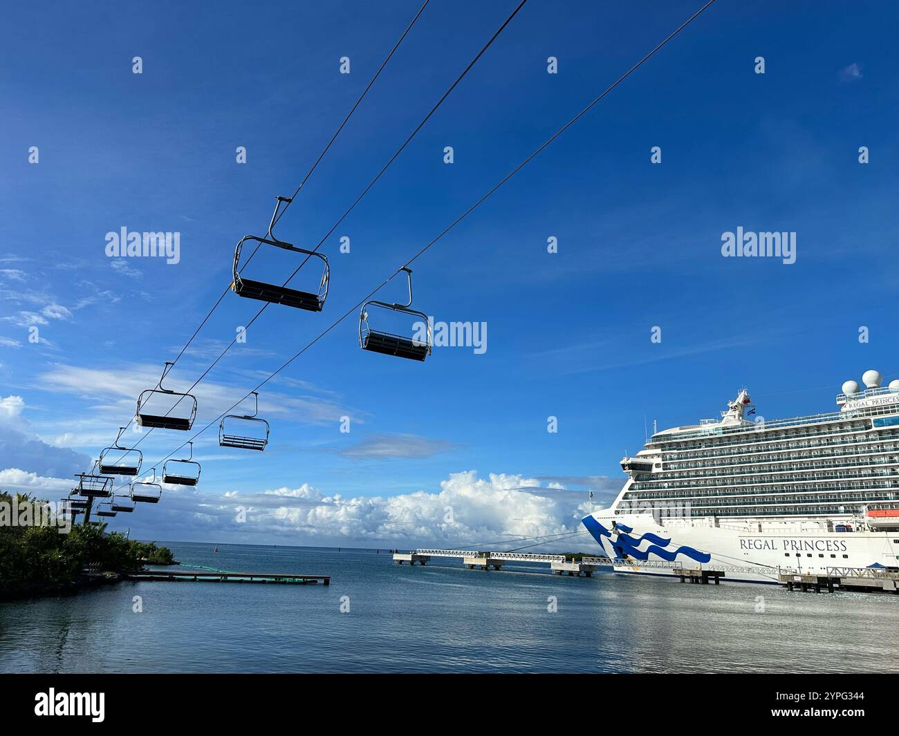 'Magical Flying Chairs' to Mahogany Beach, Mahogany Bay, Roatan, Bay Islands, Honduras, Central America. Regal Princess cruise ship to the right. - Smartphone Captured Stock Image