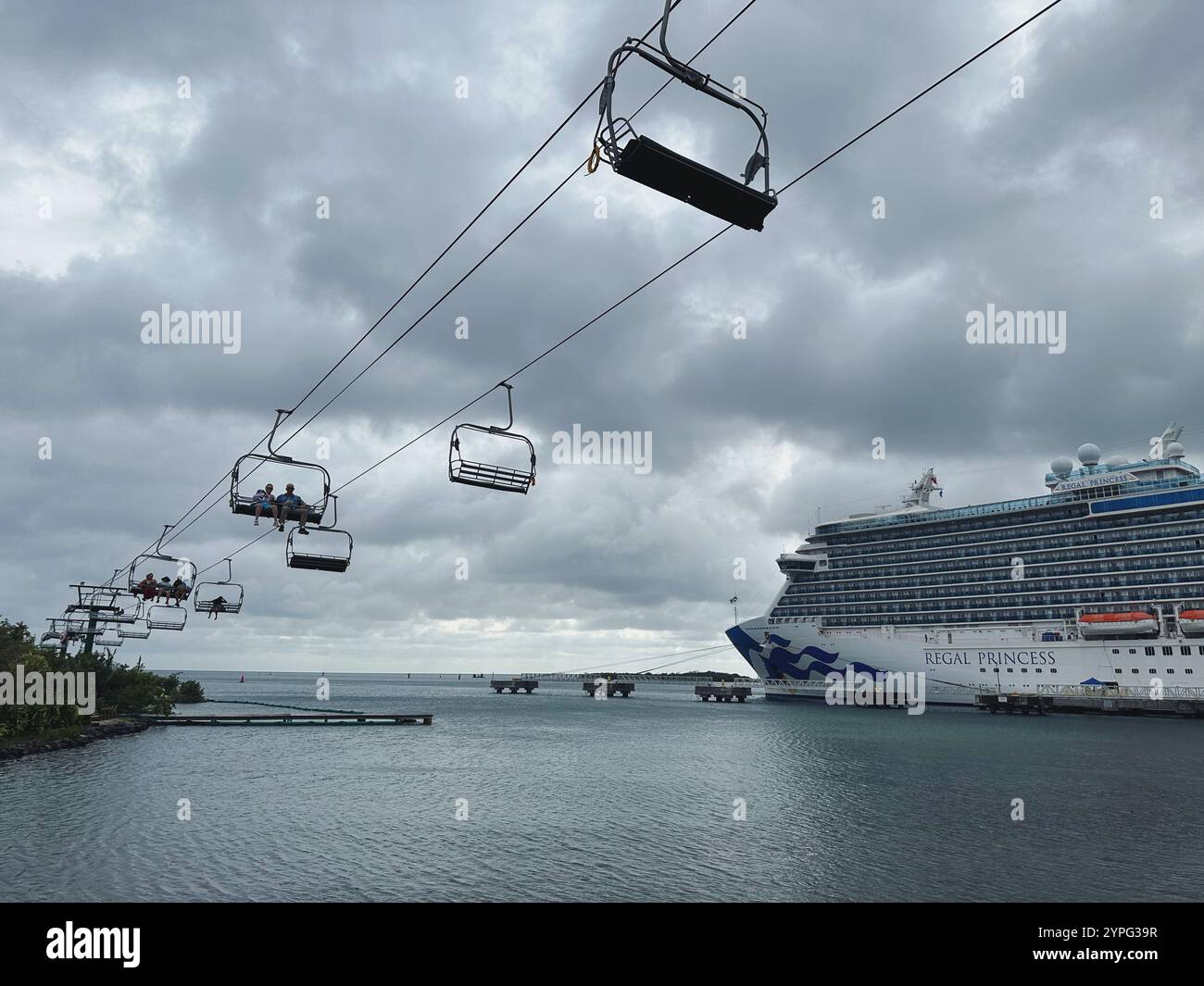 'Magical Flying Chairs' to Mahogany Beach, Mahogany Bay, Roatan, Bay Islands, Honduras, Central America. Regal Princess cruise ship to the right. - Smartphone Captured Stock Image