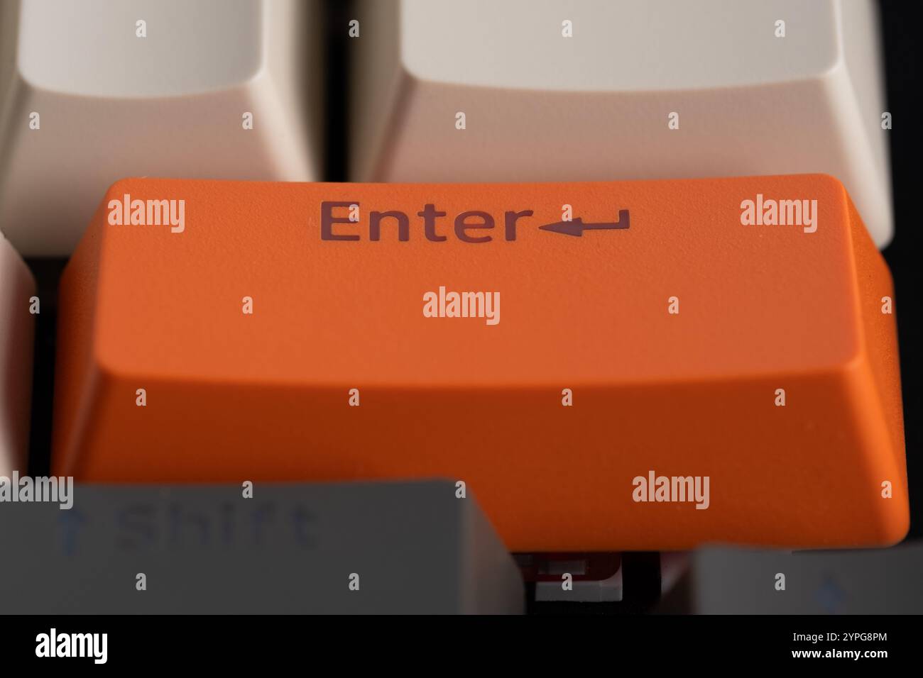 Close up of orange computer keyboard key with Enter button Stock Photo