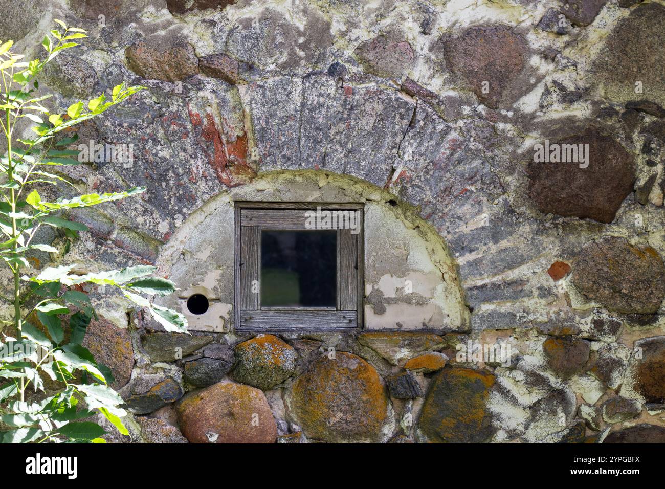 an old stone wall with a window in an arched bay Stock Photo - Alamy