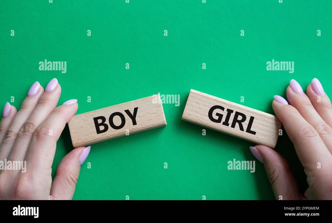 Boy or Girl symbol. Concept word Boy or Girl on wooden blocks. Man hand ...