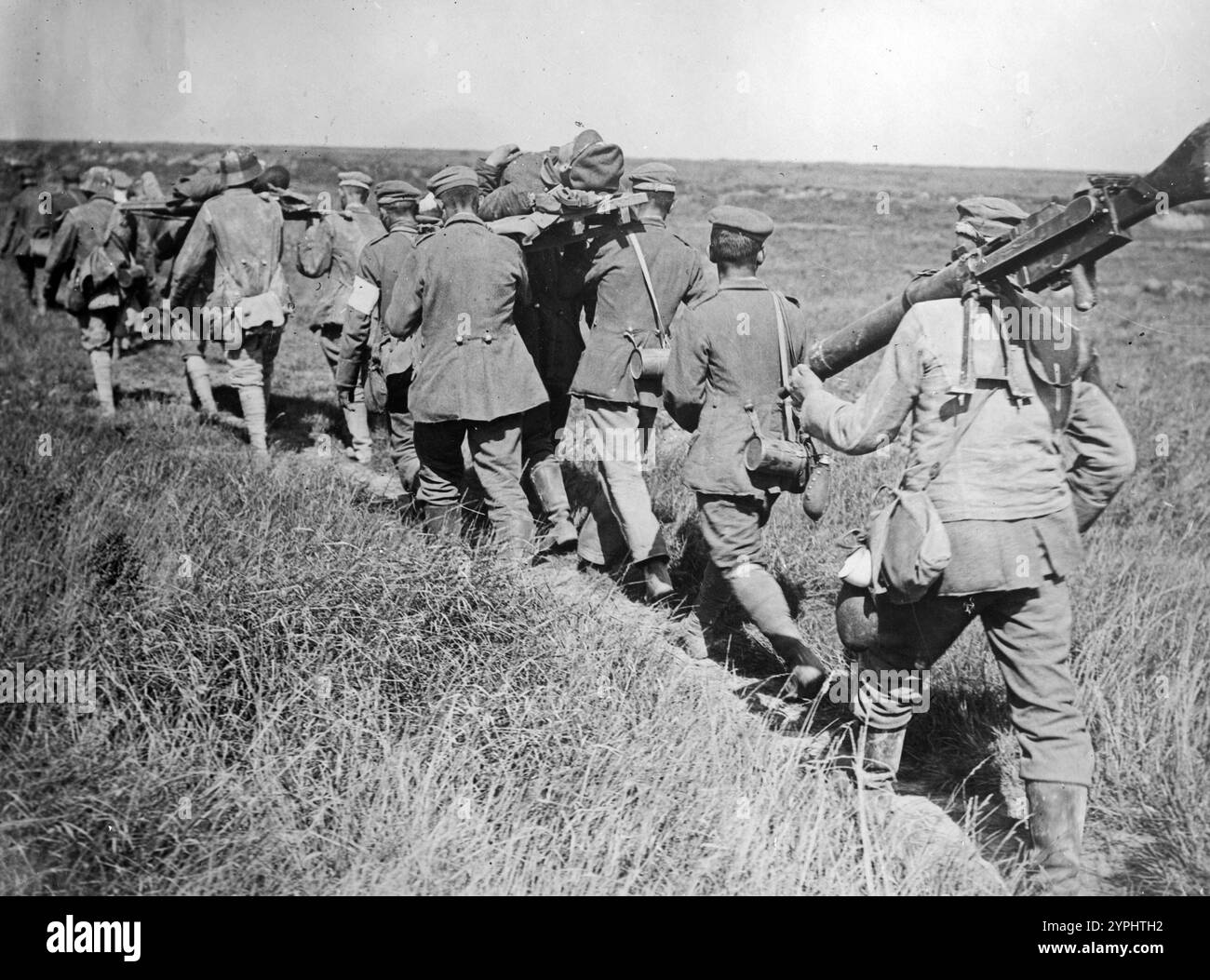 German prisoners bringing in wounded soldiers and captured machine guns during the third Battle of the Albert, near Courcelles, France, August 21, 1918 during World War I. Stock Photo
