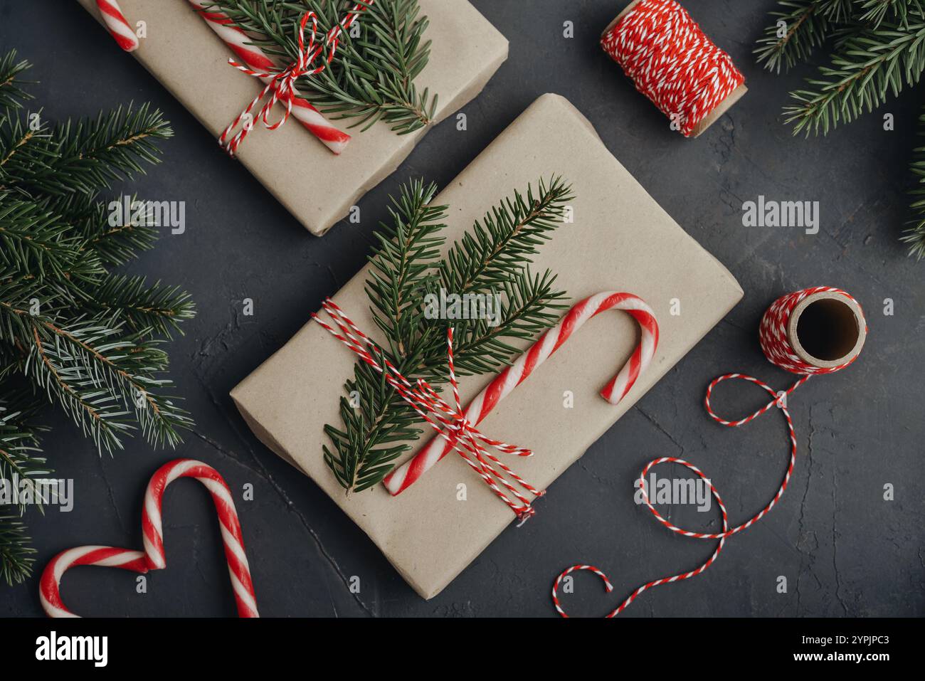 Christmas background. Gift boxes in craft paper with candy canes and ...