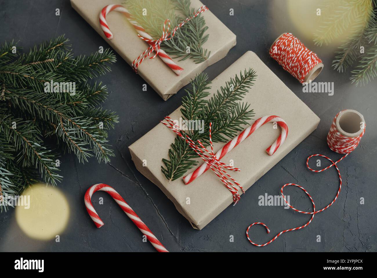 Christmas background. Gift boxes in craft paper with candy canes and ...