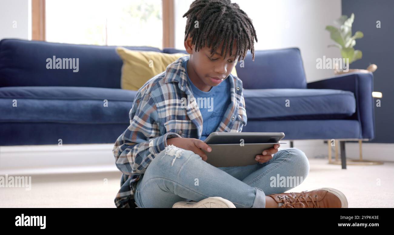 African boy sitting on floor hi-res stock photography and images - Alamy