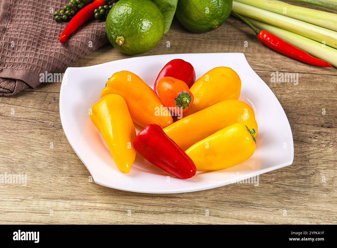 Small baby red and yellow bell pepper heap Stock Photo - Alamy