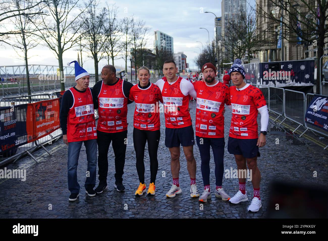 Kevin Sinfield (third right) with Peter Reid (left), John Barnes (second left), Liverpool FC Ladies Gemma Bonner, with his two support runners, before he starts his latest fundraising challenge, Running Home For Christmas, at the annual charity fundraising Liverpool Santa Dash event. Picture date: Sunday December 1, 2024. Stock Photo