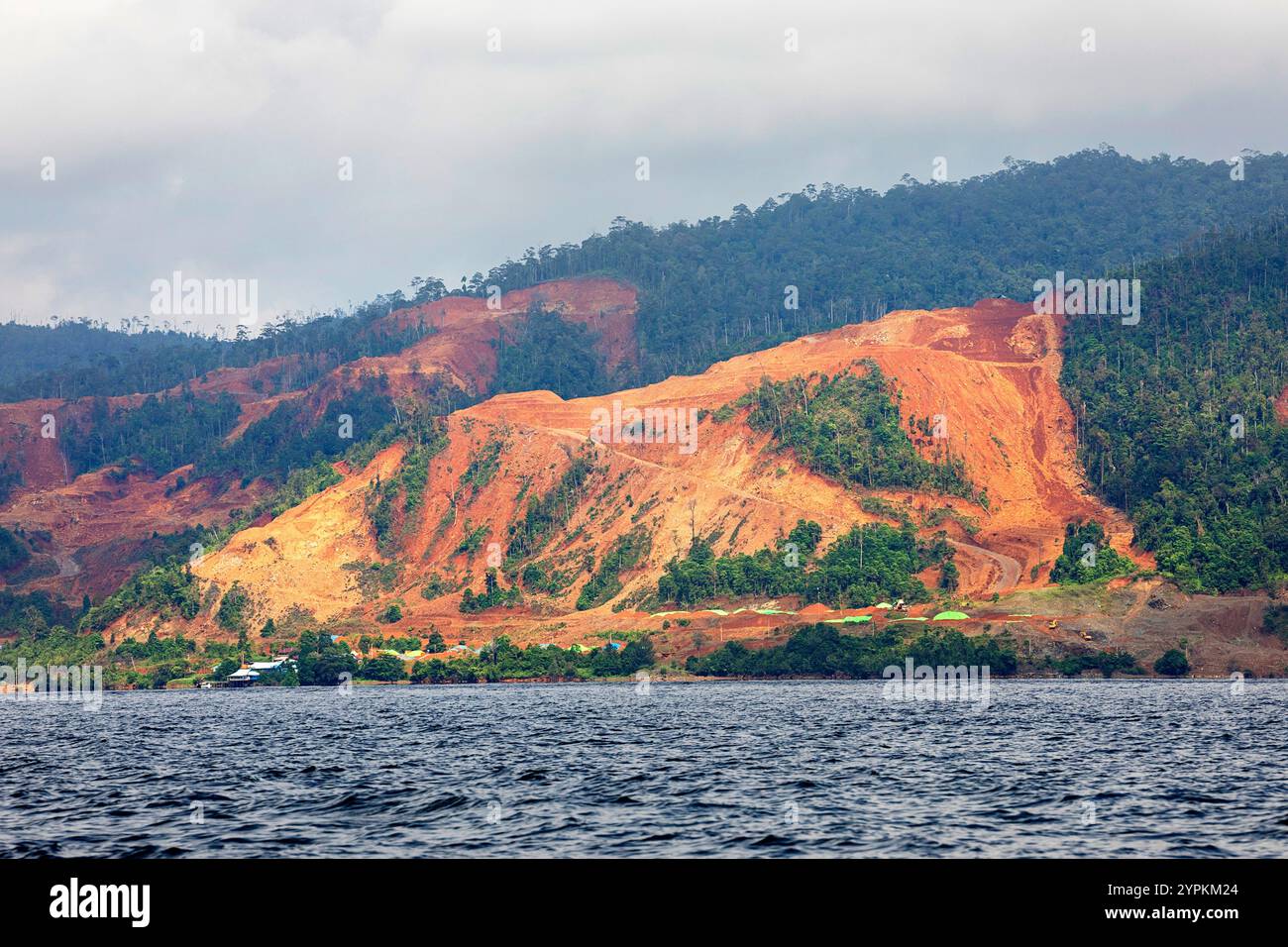 Nickel mining on a hill with lush tropical vegetation close to Kendari city on Sulawesi, open pit mining and deforestation, Indonesia Stock Photo