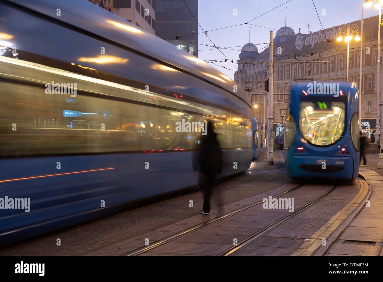 Fast electric tram passing on a city street in europe Stock Photo - Alamy