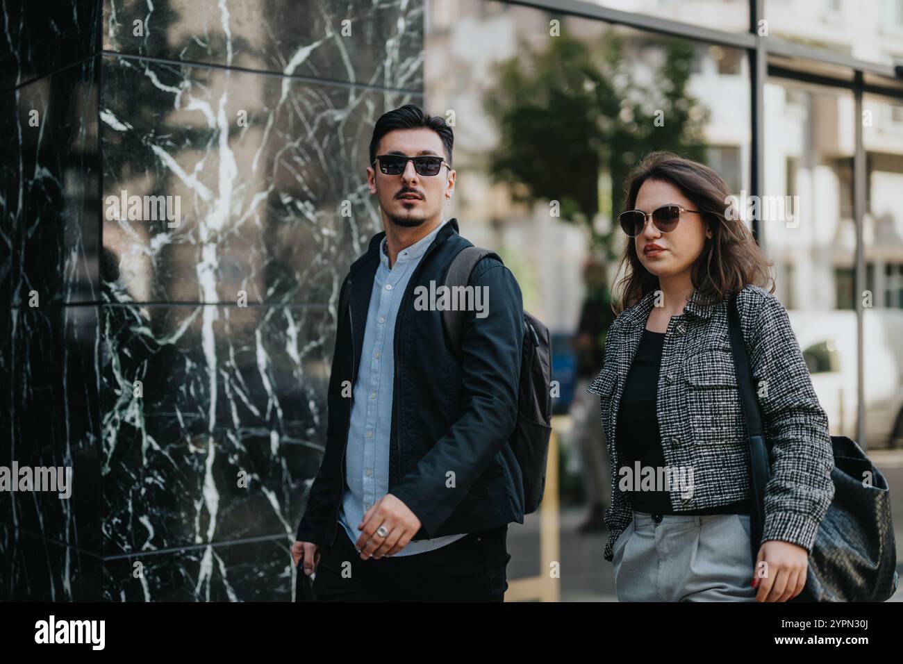Confident business people walking in urban city environment Stock Photo ...