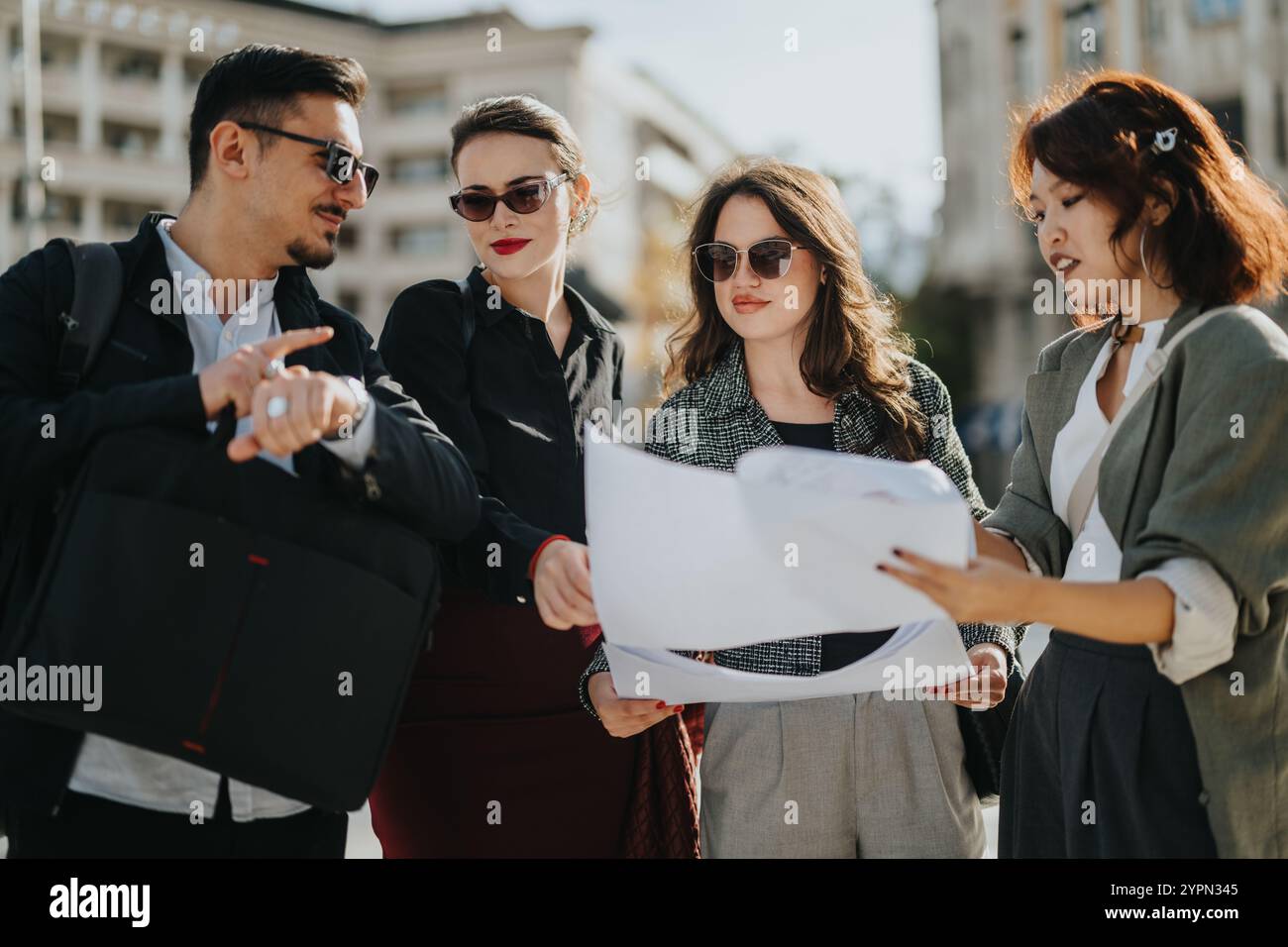Business people discussing project plans outdoors Stock Photo