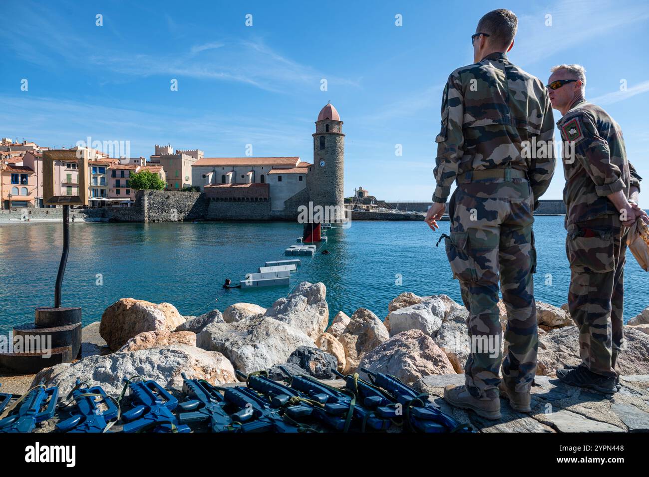 Two soldiers observe water course for training French Navy soldiers in the harbour of Collioure, Languedoc-Roussillion, France Stock Photo